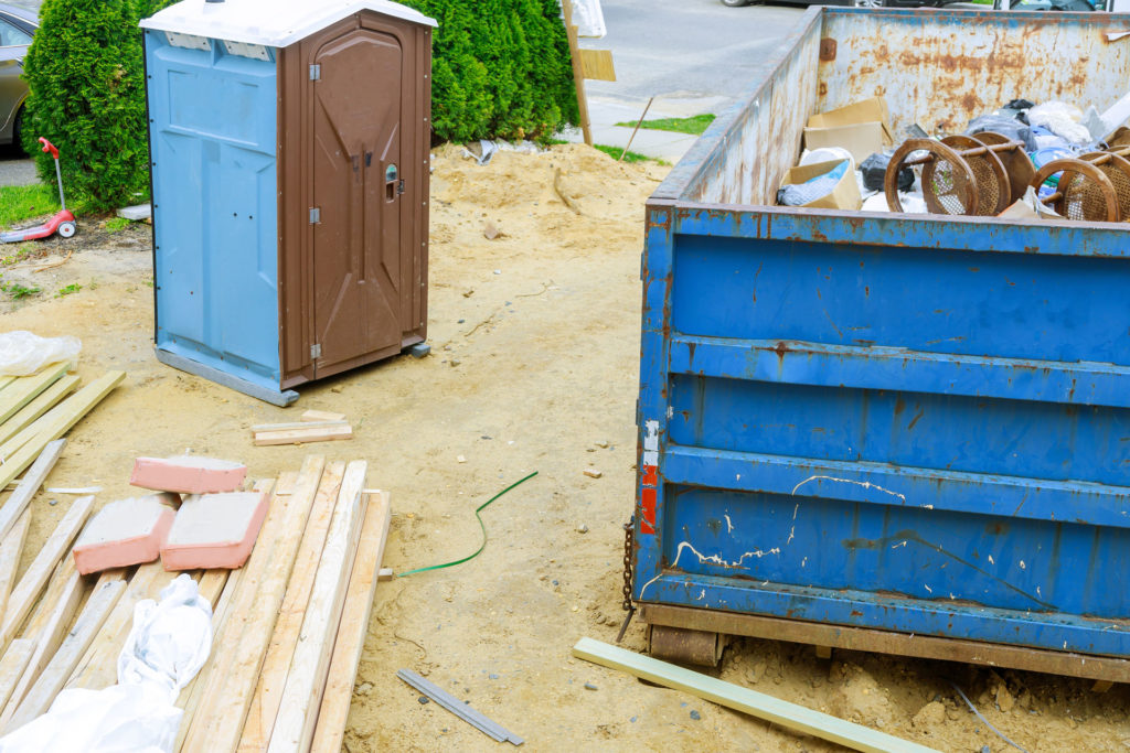 Porta Potty and dumpster on construction site
